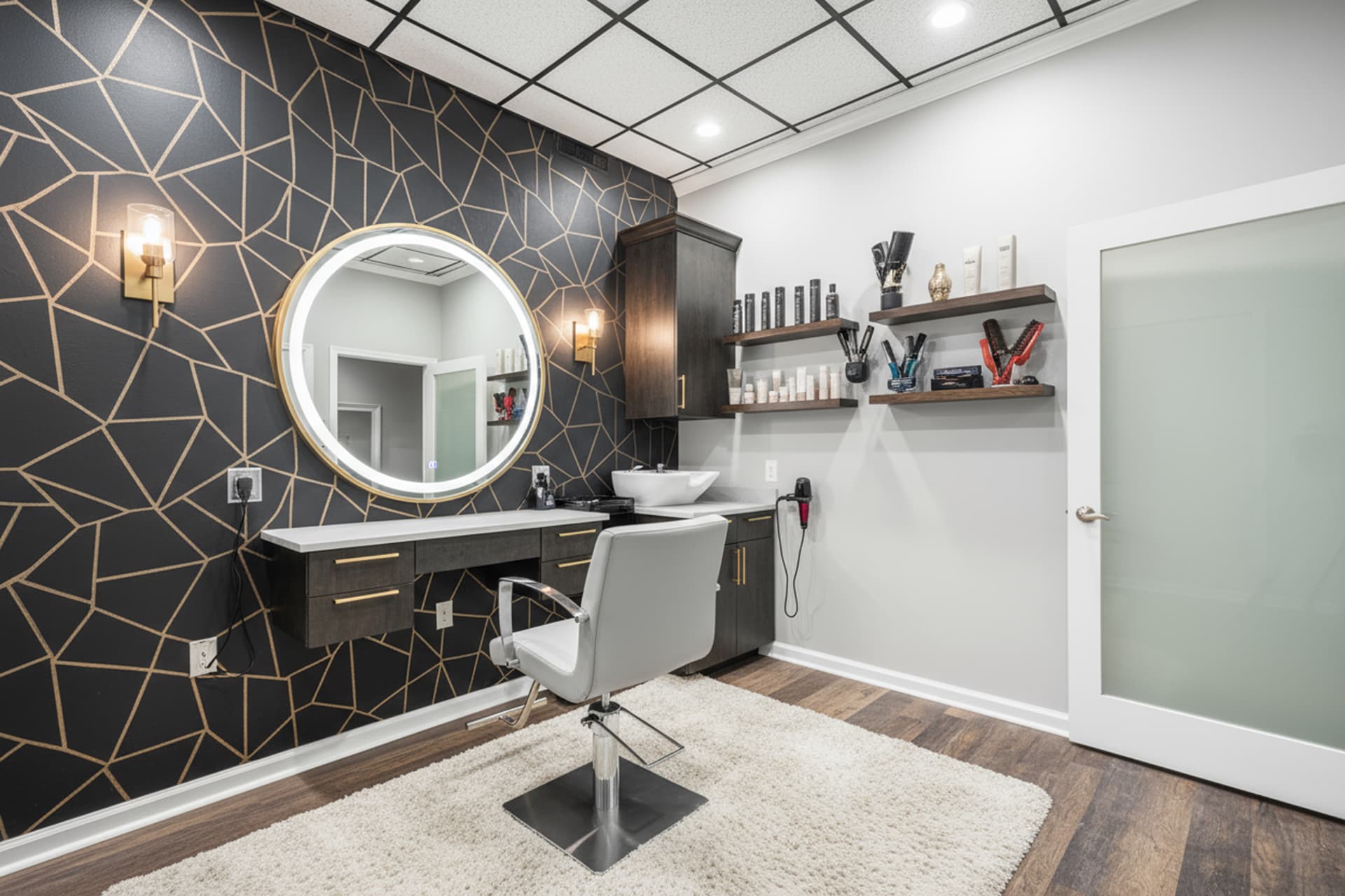 Private Pikesville salon suite with a lighted mirror, styling chair, and product shelves
